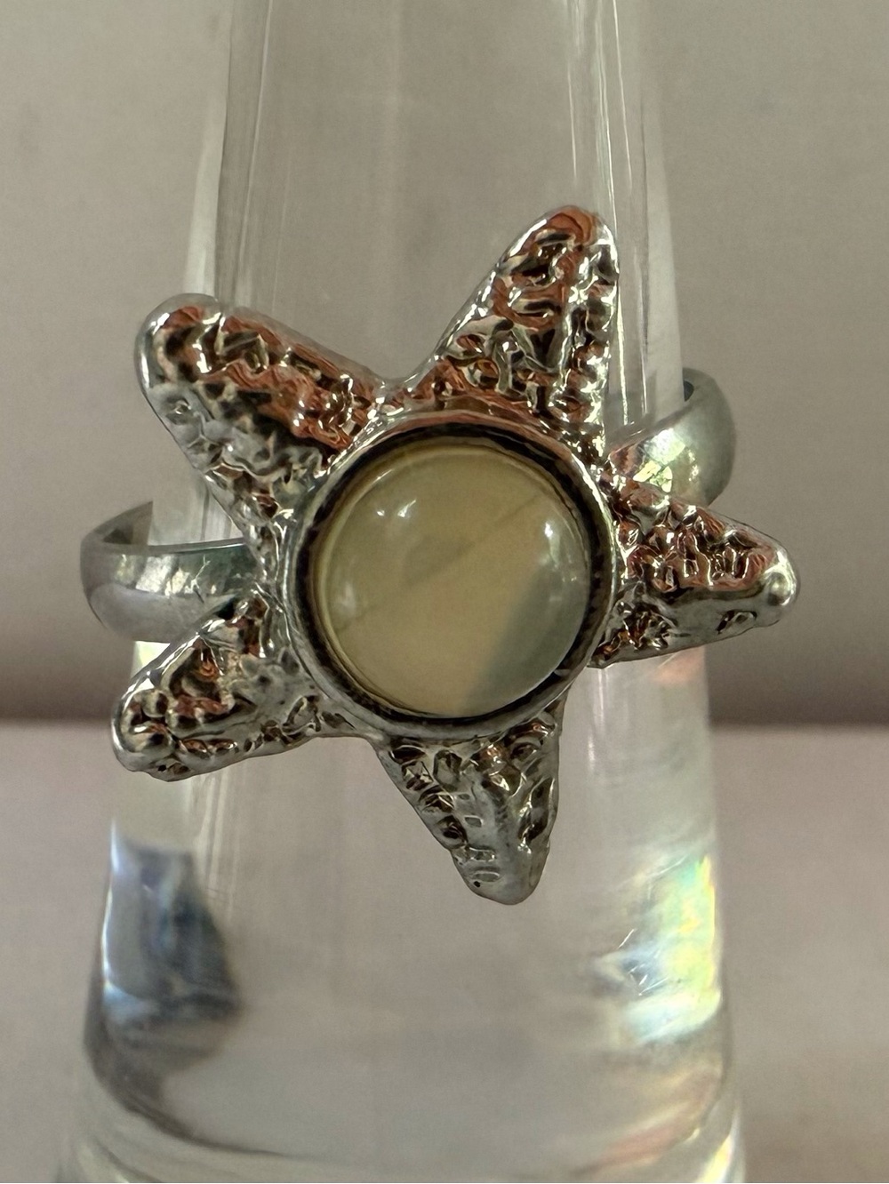 Starfish Ring sitting at size 4.5 adjustable with Cream Cabochon